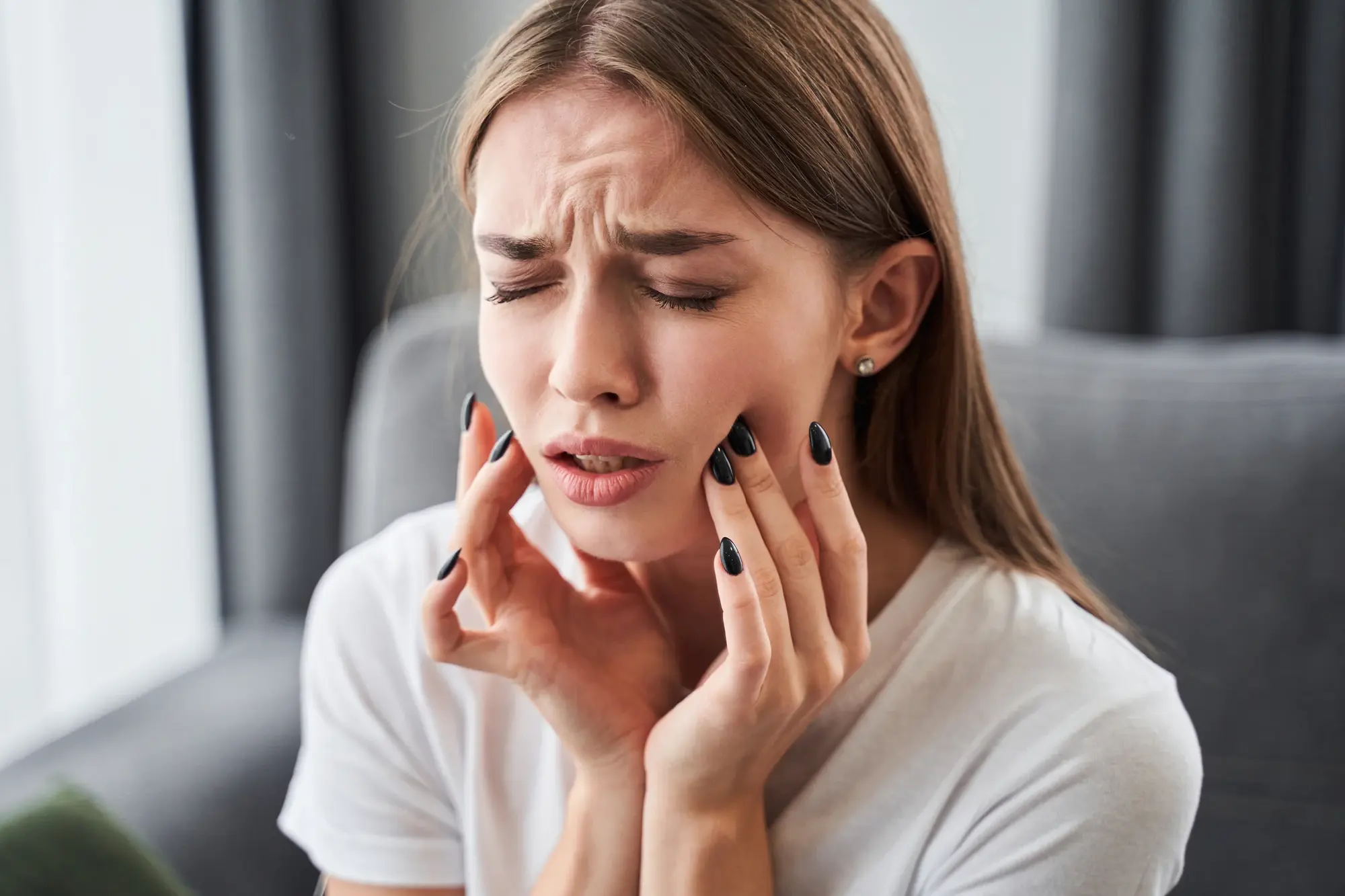 Woman holding her jaw